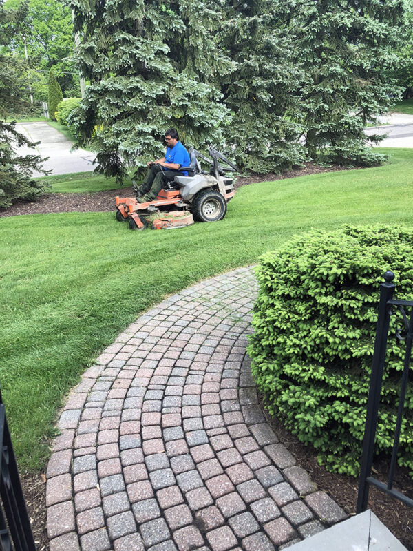 Man mowing lawn on riding mower